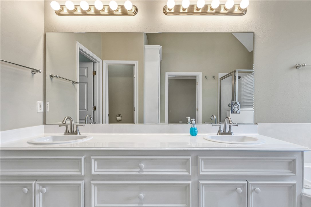 1602 Leopard Court College Station, TX 77840 - Photo 18 of 28 a bathroom with a sink and a mirror