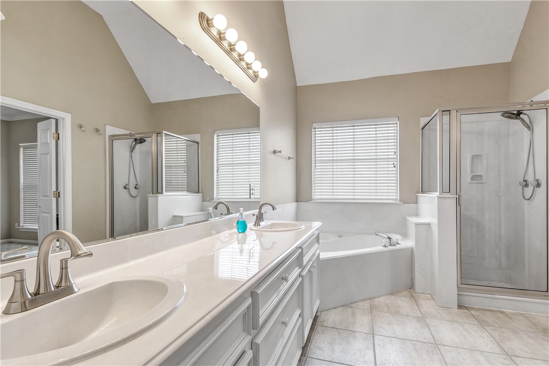 1602 Leopard Court College Station, TX 77840 - Photo 19 of 28 a bathroom with a tub sink and mirror