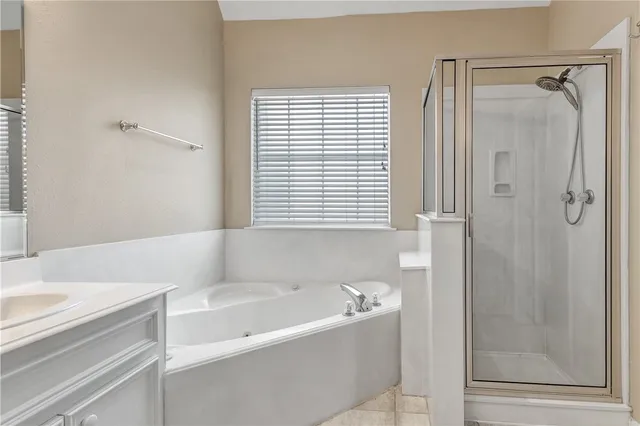 a bathroom with a bathtub and a shower