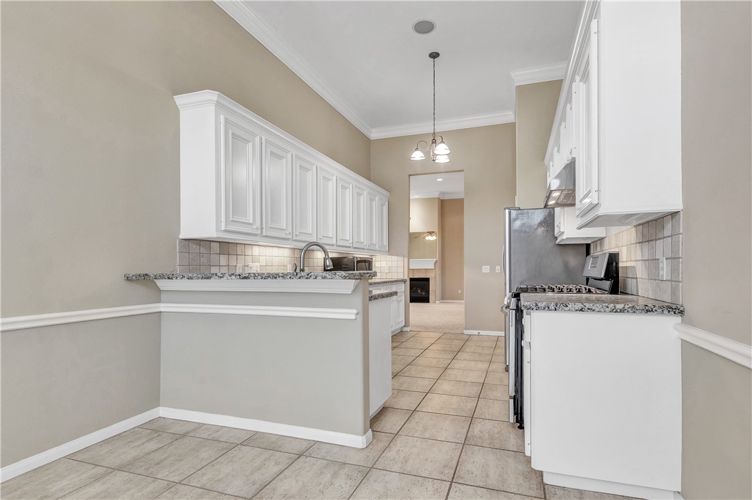1602 Leopard Court College Station, TX 77840 - Photo 4 of 28 a kitchen with a stove cabinets and a refrigerator