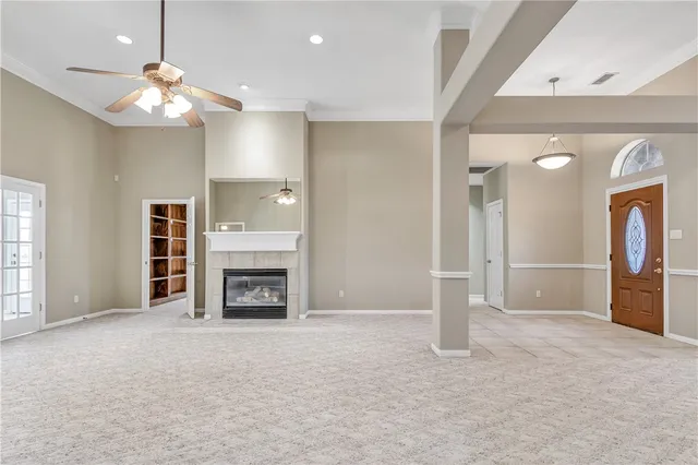 an empty room with a fireplace and fan