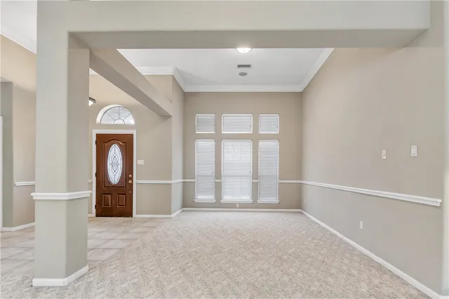 an empty room with mirror and a window