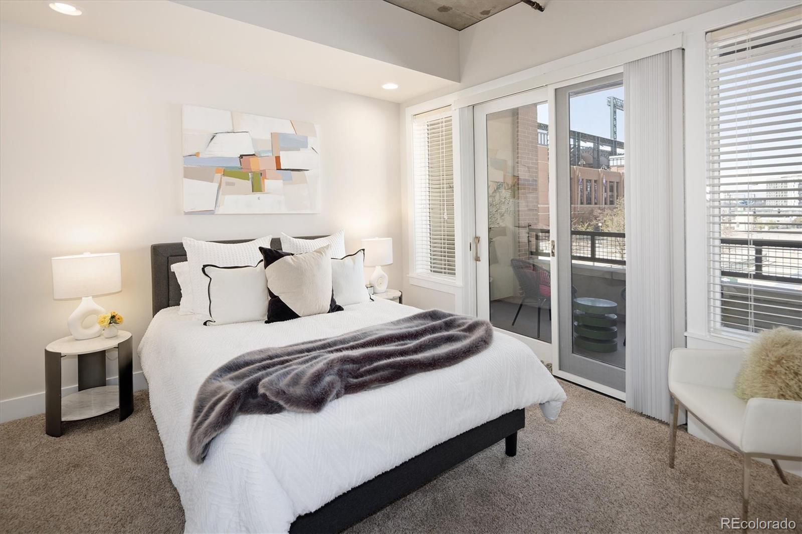 2210 Blake Street, Unit 209 Denver, CO 80205 - Photo 20 of 33 a spacious bedroom with a bed and a window