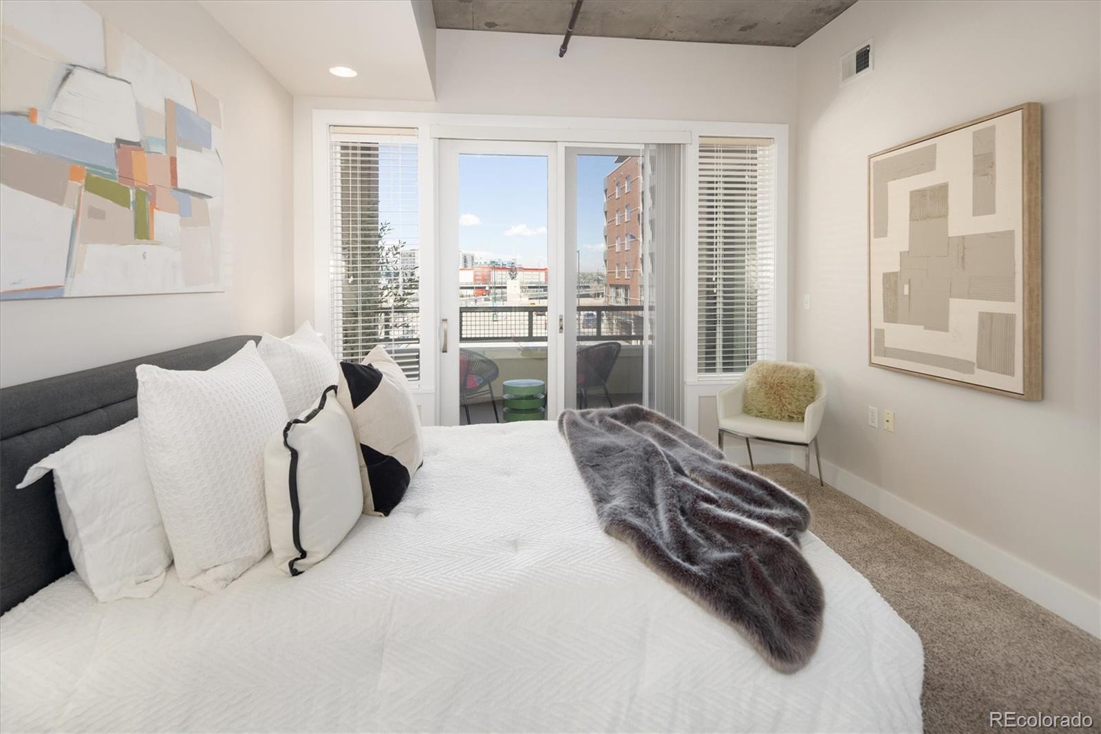 2210 Blake Street, Unit 209 Denver, CO 80205 - Photo 22 of 33 a bedroom with a bed and a large window