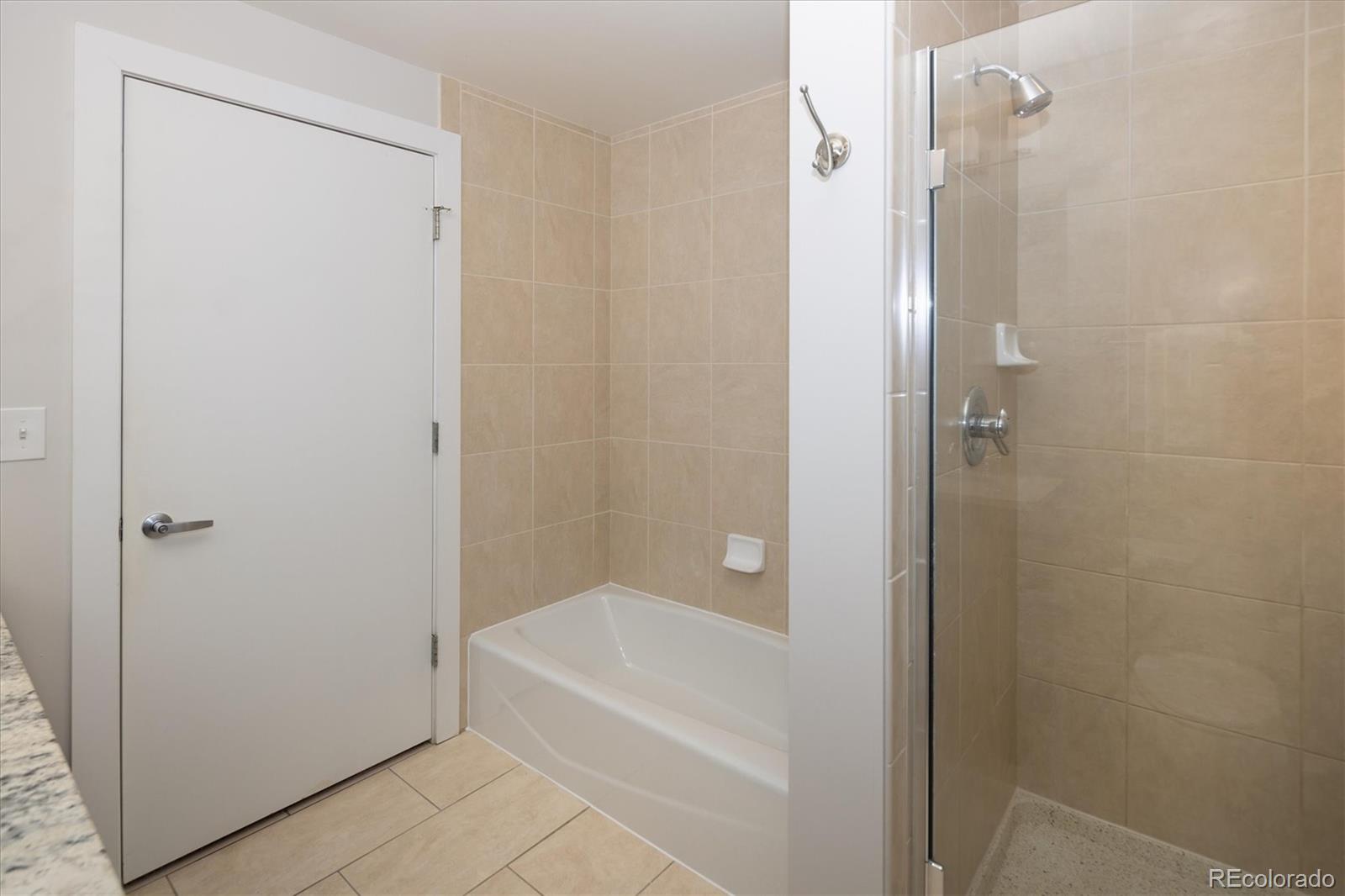 2210 Blake Street, Unit 209 Denver, CO 80205 - Photo 25 of 33 a bathroom with a bathtub