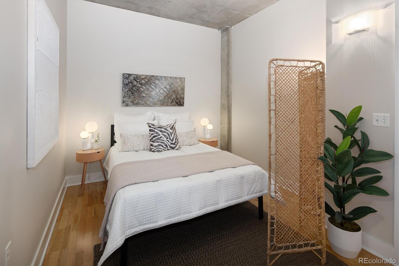 2210 Blake Street, Unit 209 Denver, CO 80205 - Photo 27 of 33 a bedroom with a bed potted plant and a window