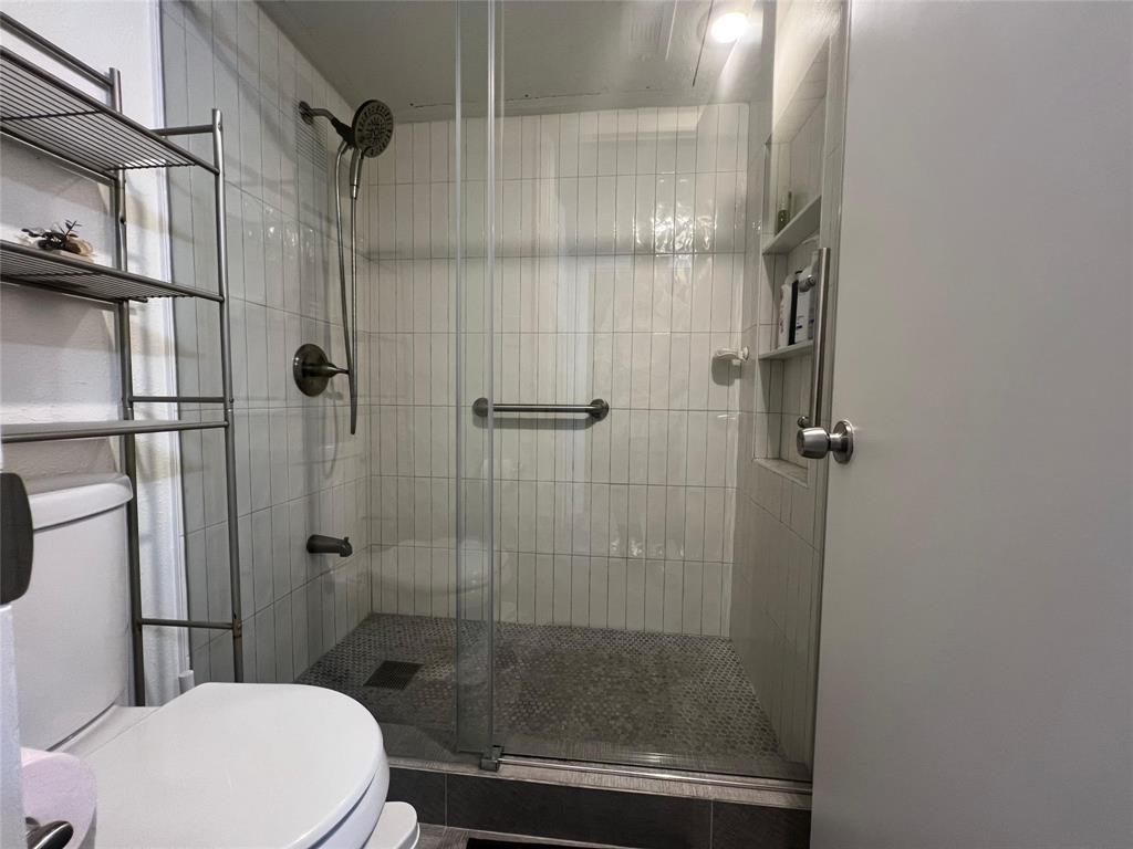 4569 North O'Connor Road, Unit 2318 Irving, TX 75062 - Photo 4 of 9 a bathroom with a shower and toilet