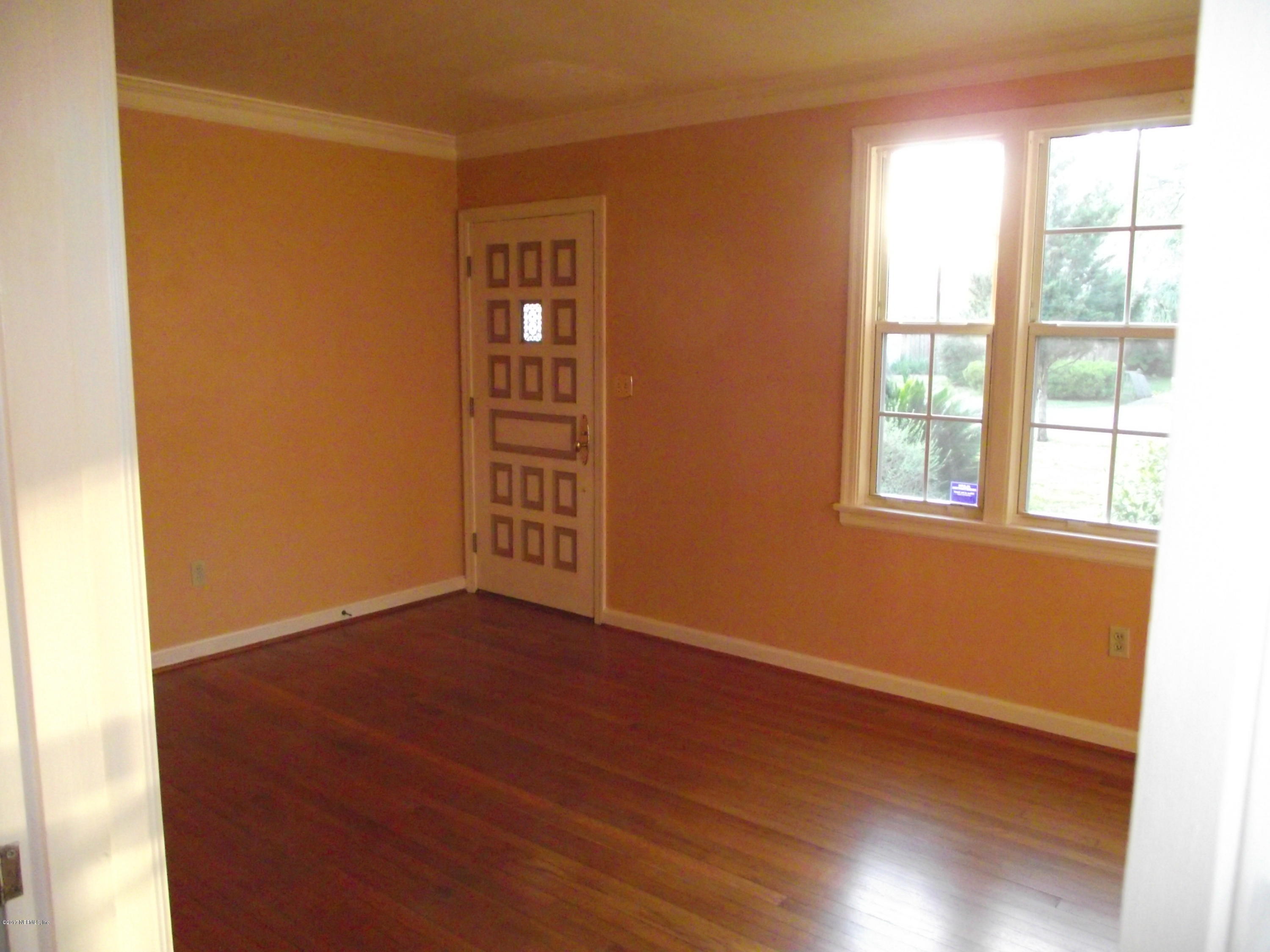 4171 Gadsden Road Jacksonville, FL 32207 - Photo 6 of 26 an empty room with wooden floor and windows