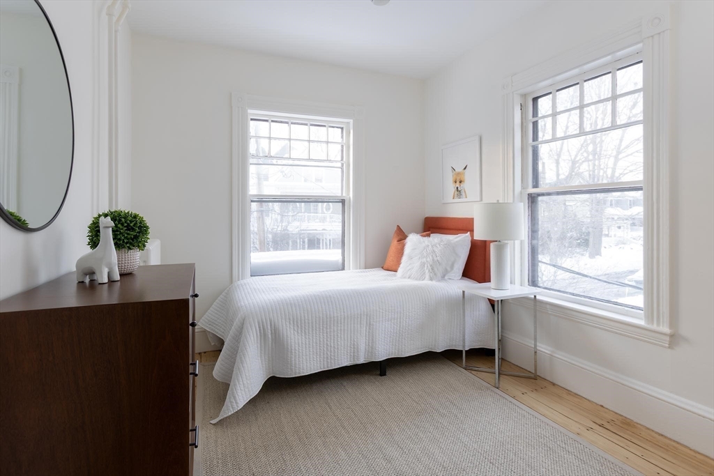 61 Toxteth Street Brookline, MA 02446 - Photo 14 of 21 a bedroom with a bed table and window