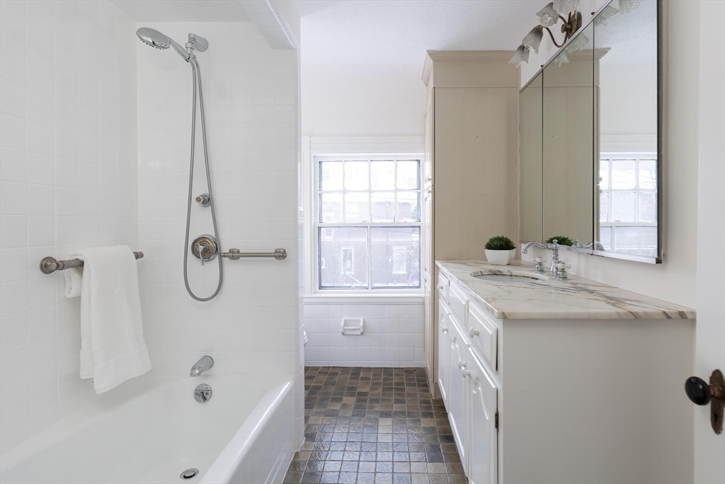 61 Toxteth Street Brookline, MA 02446 - Photo 17 of 21 a bathroom with a granite countertop sink a toilet and shower