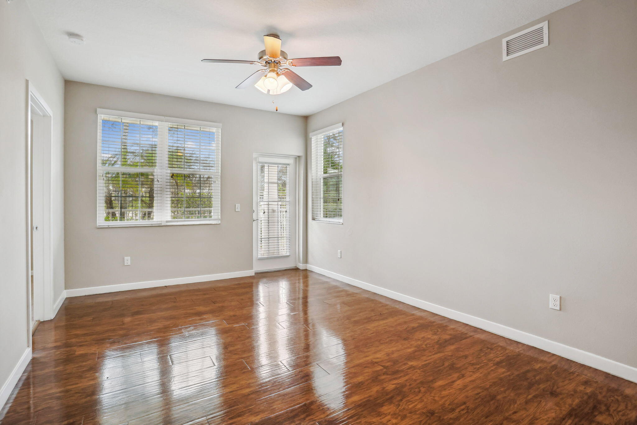 3613 High Ridge Road, Unit 304 Boynton Beach, FL 33426 - Photo 11 of 32 a view of an empty room with wooden floor and a window