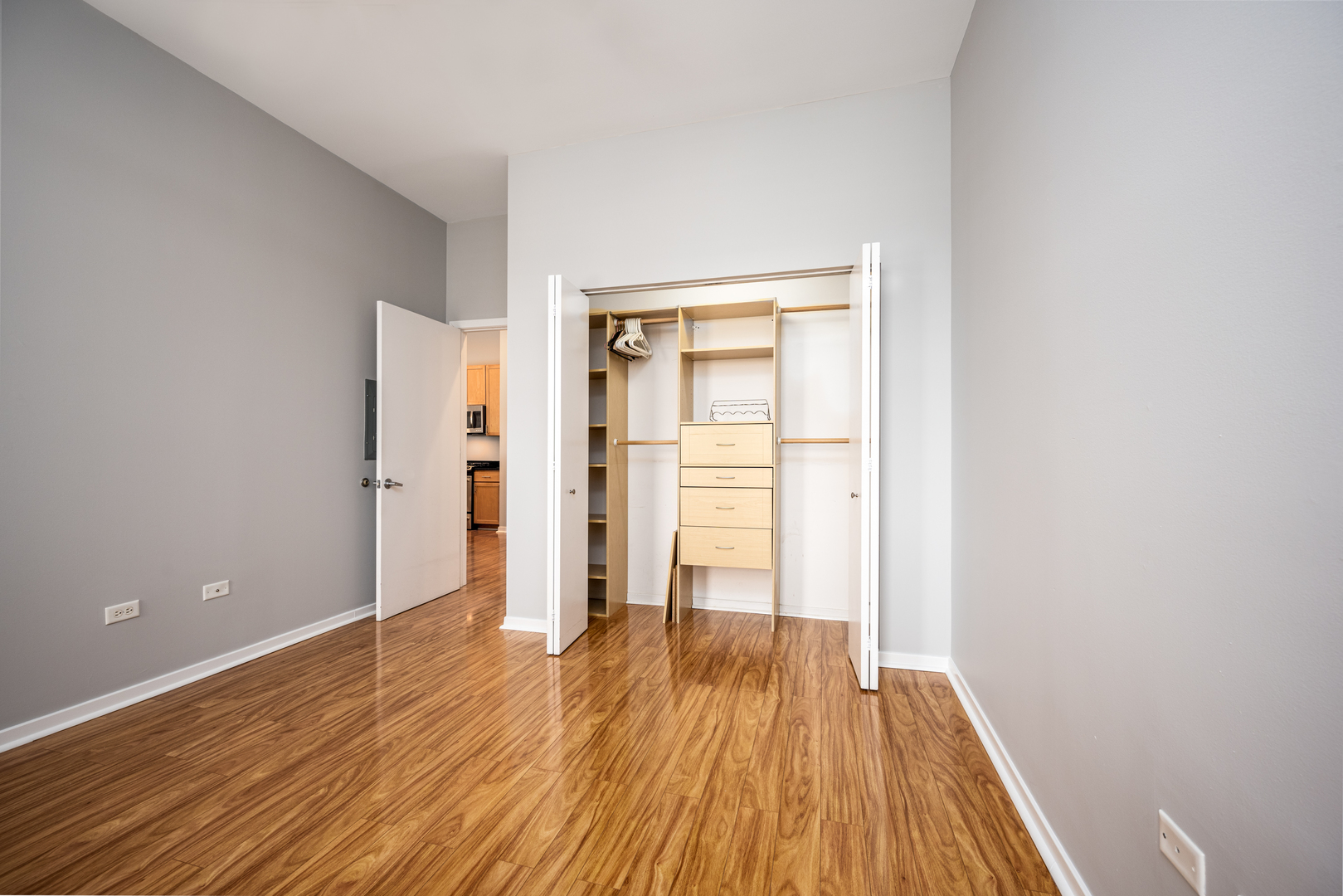 3920 North Sheridan Road, Unit 406 Chicago, IL 60613 - Photo 7 of 12 wooden floor in an empty room with a window