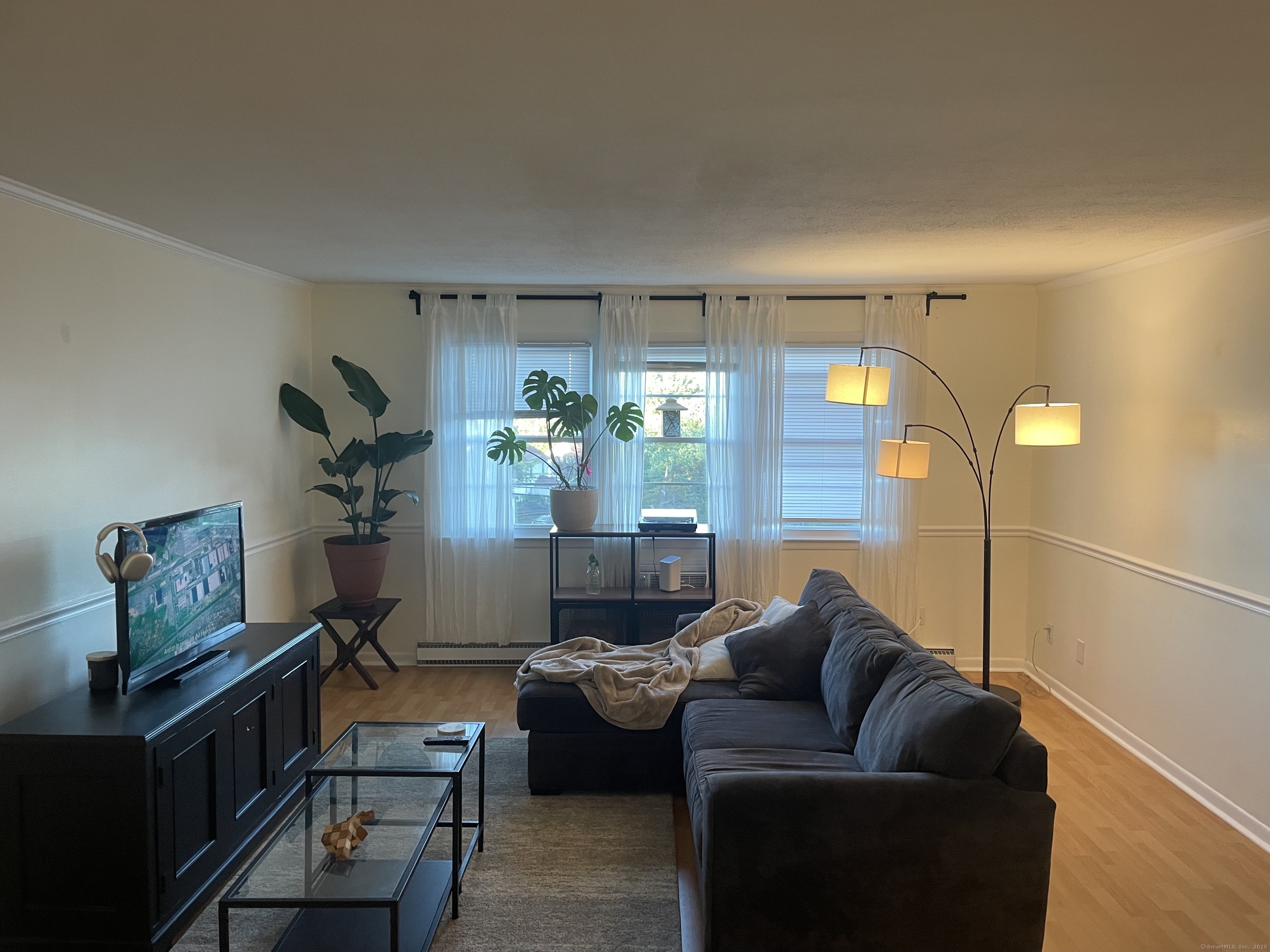 a living room with furniture and a chandelier