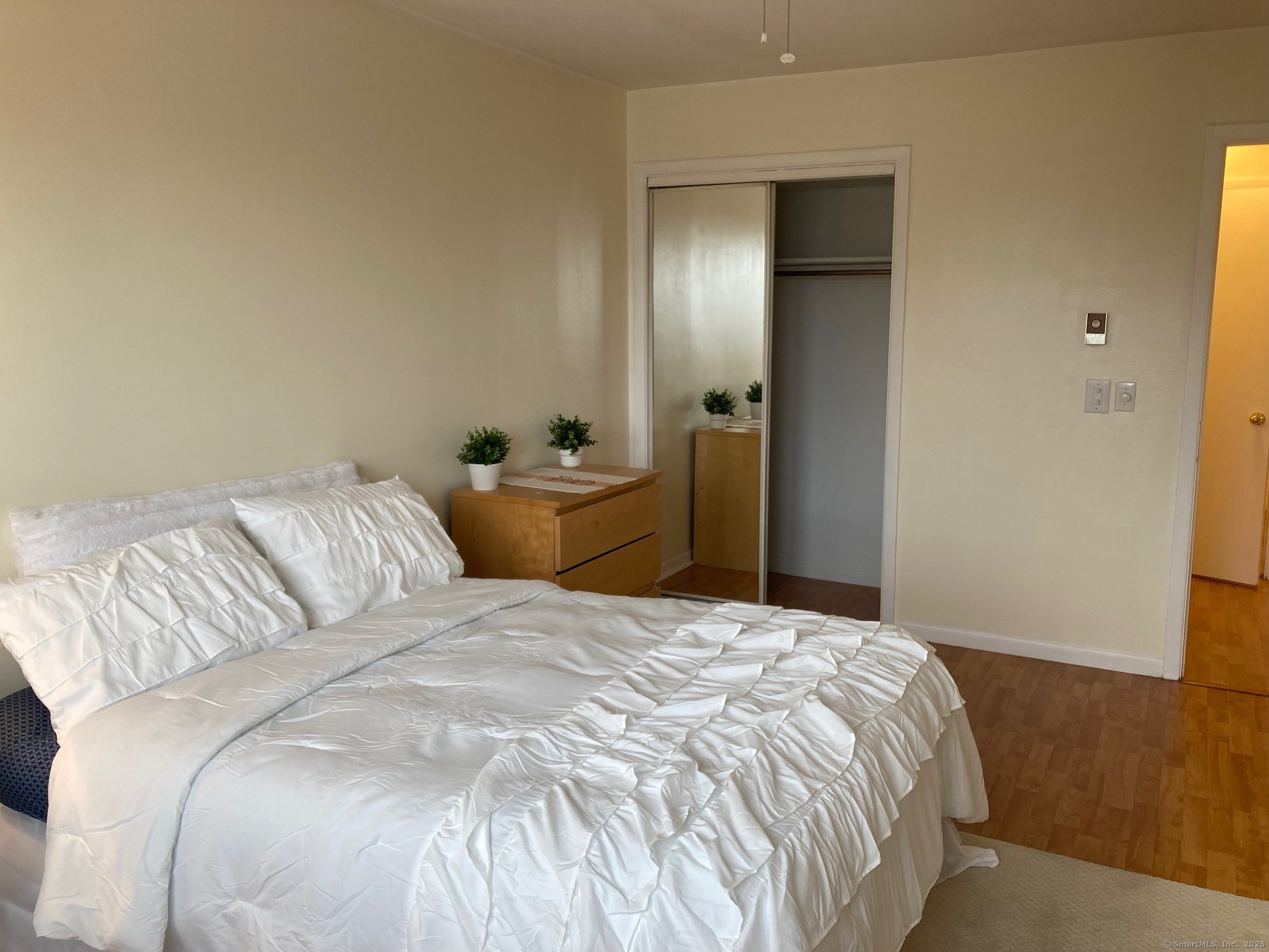 1730 State Street, Unit 302 Hamden, CT 06517 - Photo 11 of 18 a bedroom with a bed and wooden floor