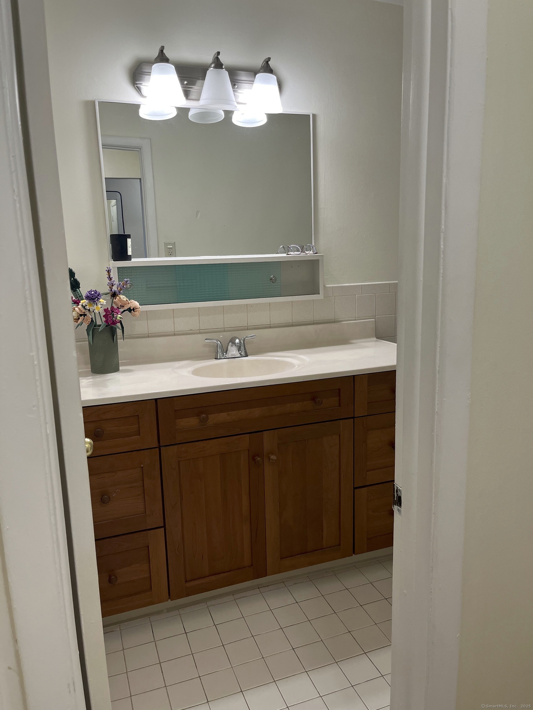 1730 State Street, Unit 302 Hamden, CT 06517 - Photo 13 of 18 a bathroom with a sink and a mirror