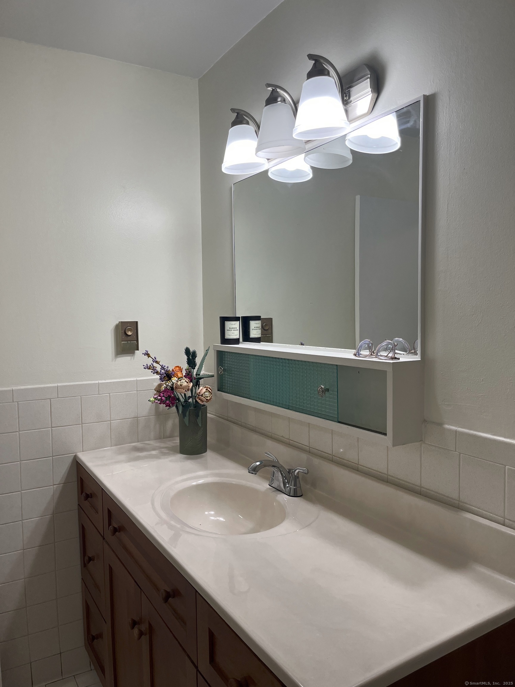 1730 State Street, Unit 302 Hamden, CT 06517 - Photo 14 of 18 a bathroom with a sink and a mirror