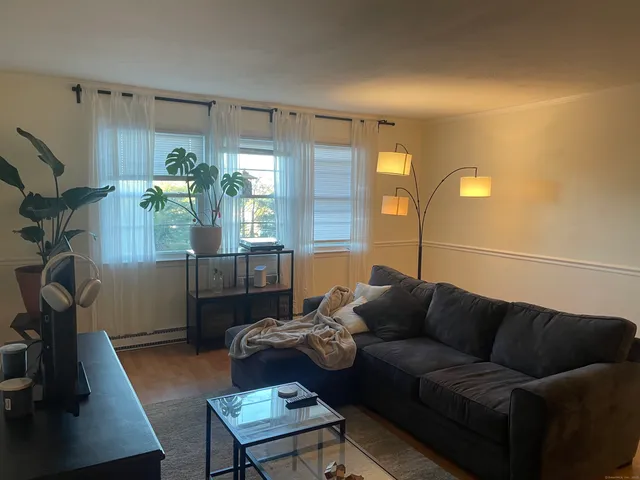 a living room with furniture and a lamp