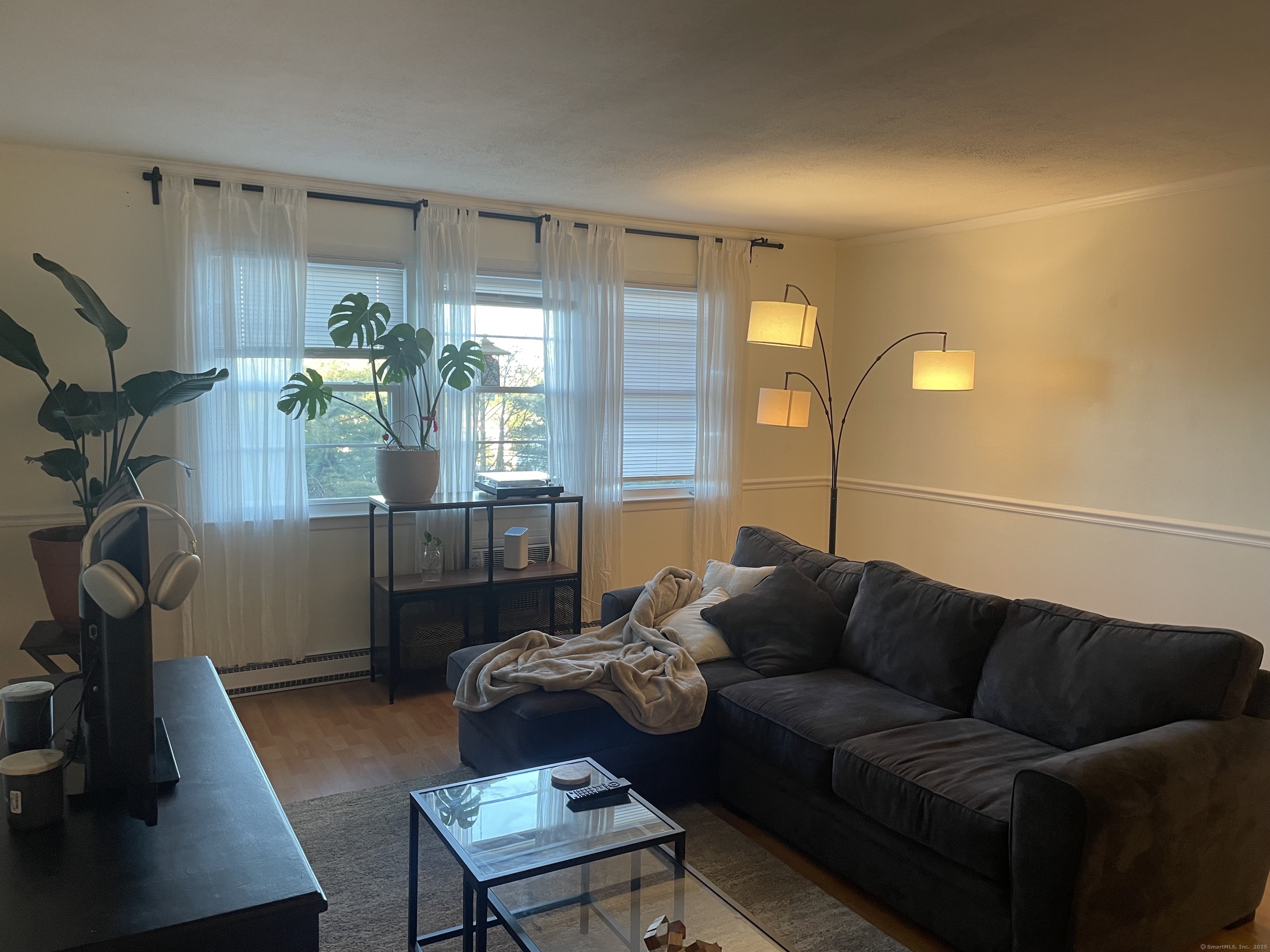 1730 State Street, Unit 302 Hamden, CT 06517 - Photo 3 of 18 a living room with furniture and a lamp