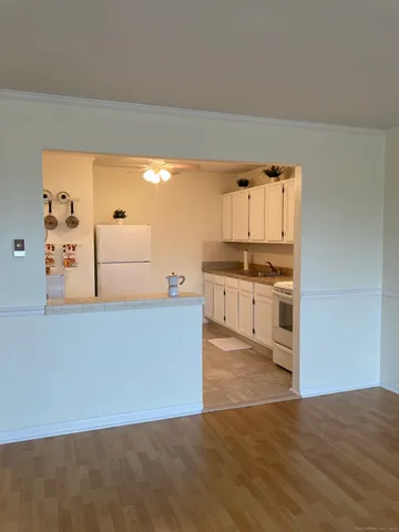 a kitchen with granite countertop a stove and a refrigerator