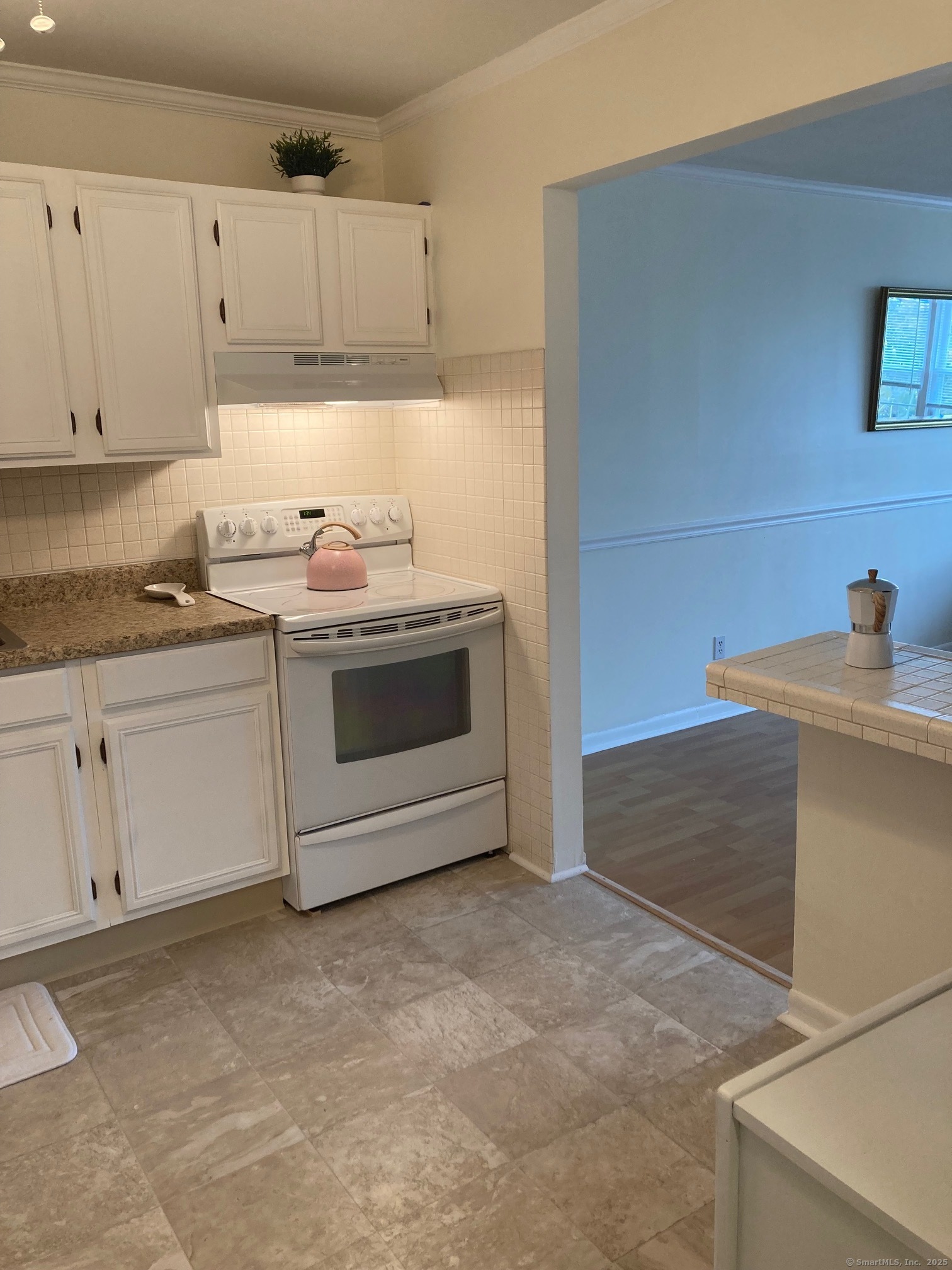 1730 State Street, Unit 302 Hamden, CT 06517 - Photo 6 of 18 a kitchen with granite countertop white cabinets and white stainless steel appliances