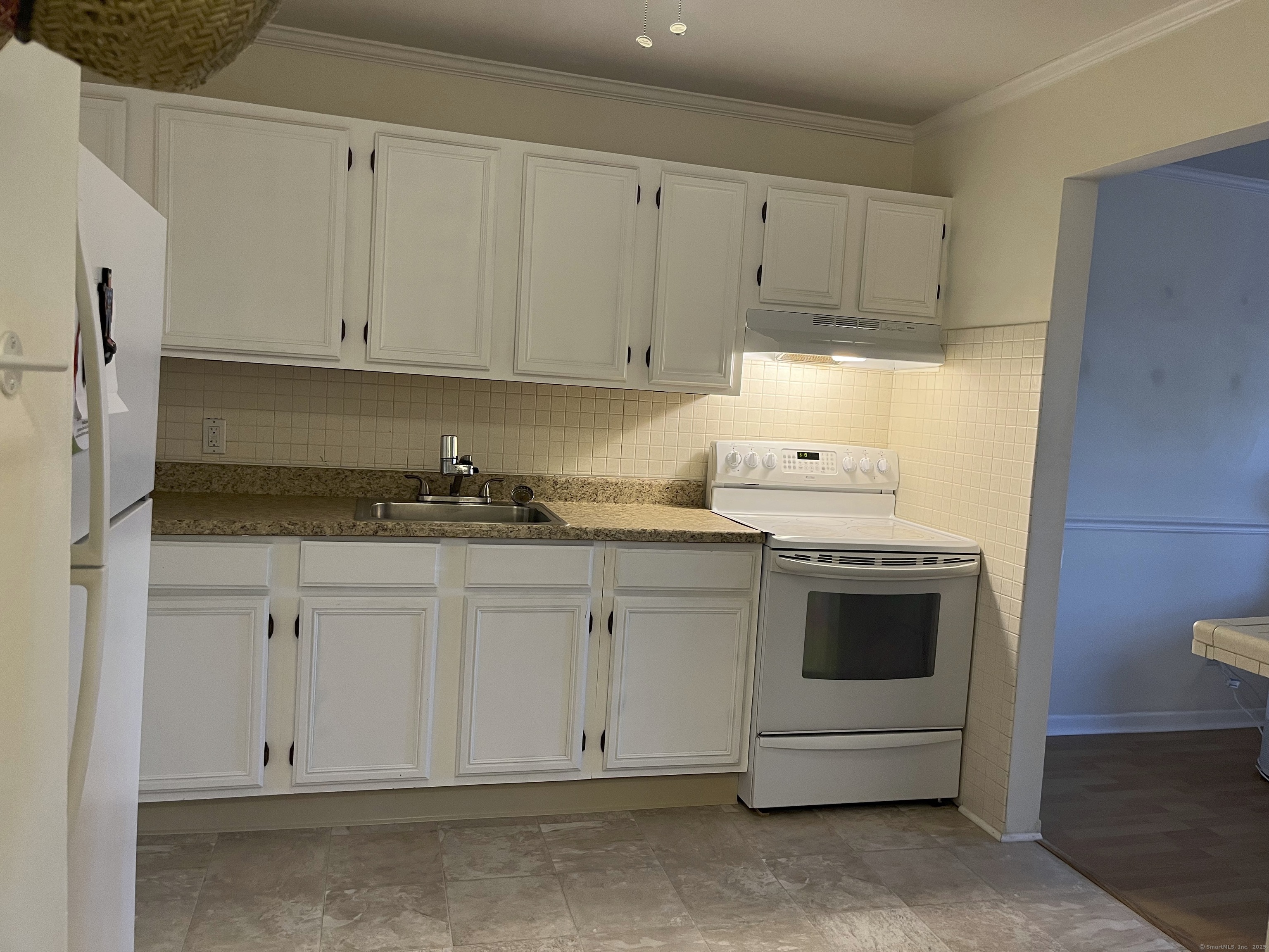 1730 State Street, Unit 302 Hamden, CT 06517 - Photo 7 of 18 a kitchen with granite countertop white cabinets and white appliances