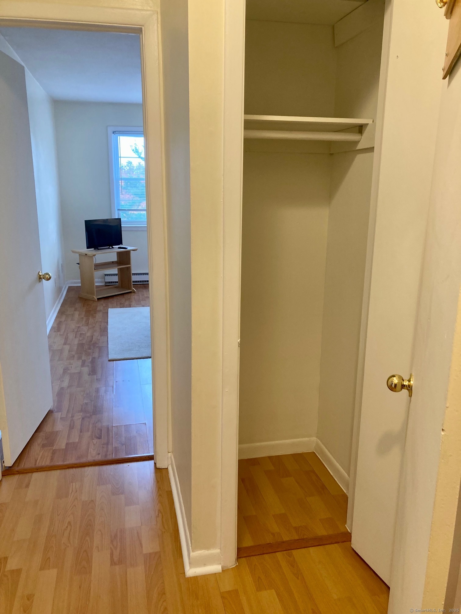 1730 State Street, Unit 302 Hamden, CT 06517 - Photo 9 of 18 a view of a hallway with wooden floor and a bathroom