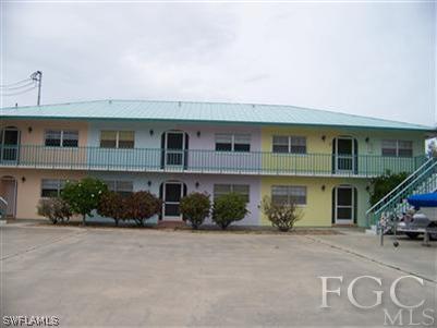 3215 Stringfellow Road, Unit 204 St. James City, FL 33956 - Photo 1 of 6 a front view of a house with plants