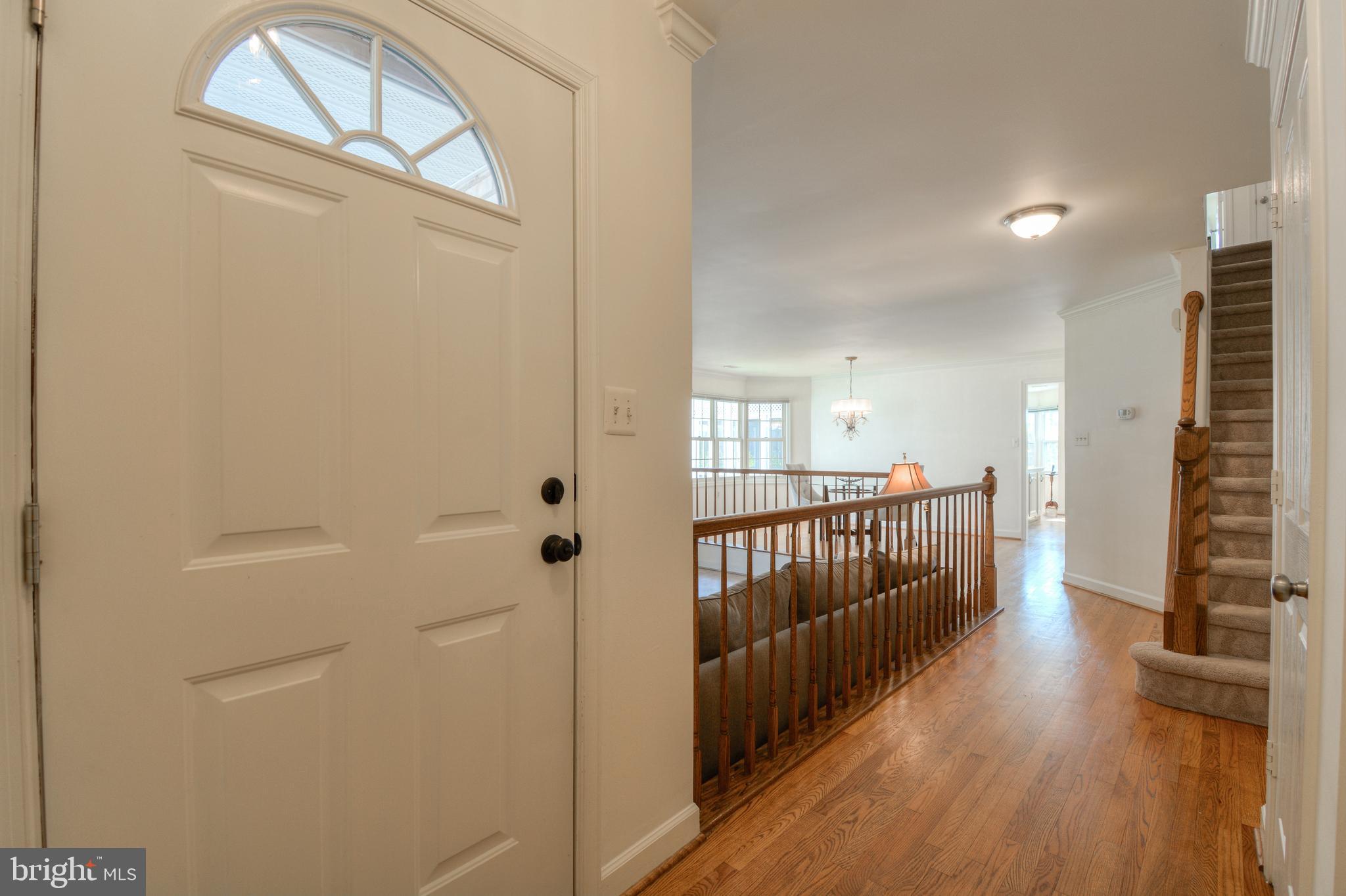 2457 Bear Den Road Frederick, MD 21701 - Photo 4 of 36 a view of a hallway with wooden floor and stairs