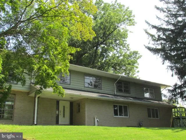 a front view of a house with yard and garage