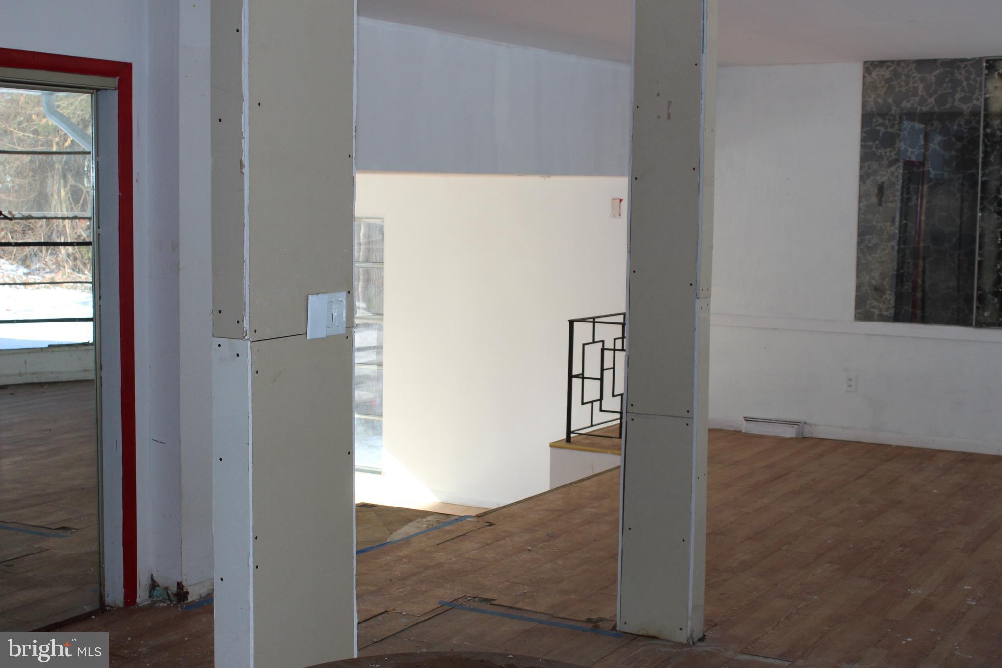 1048 Upper River Road Ewing, NJ 08628 - Photo 5 of 16 a view of a hallway with an entryway and wooden floor