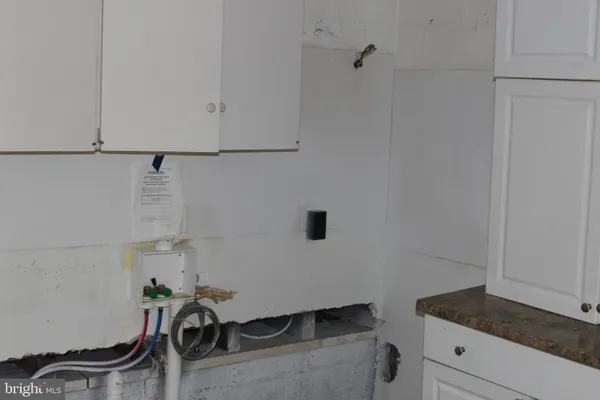 a view of a storage and utility room with racks on the wall