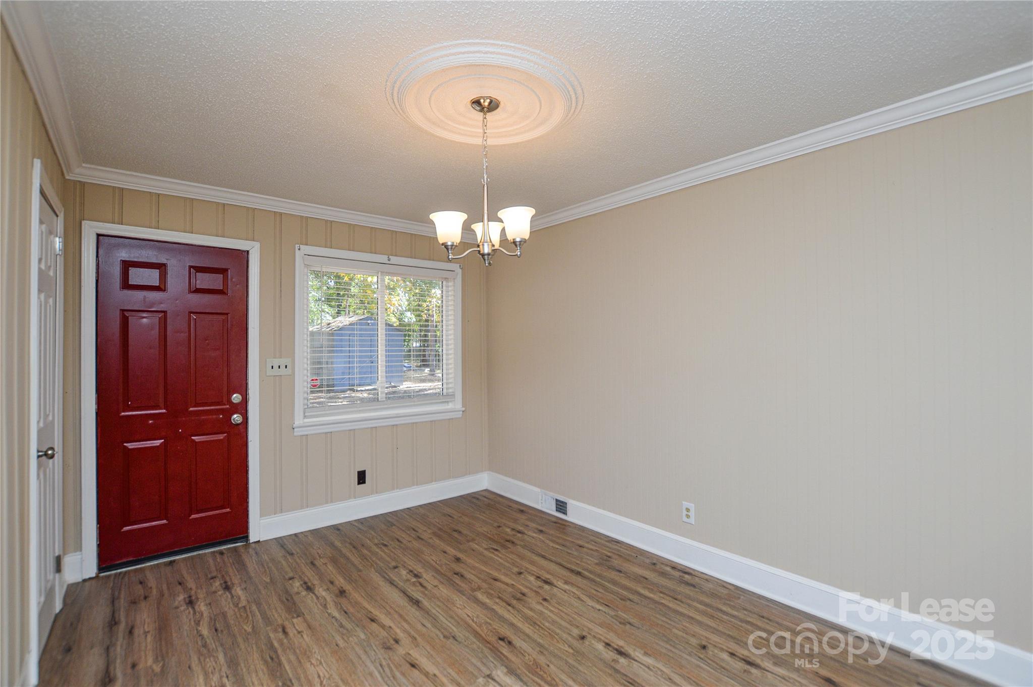 2511 Woodstar Road Matthews, NC 28105 - Photo 13 of 21 a view of an empty room with wooden floor and a window