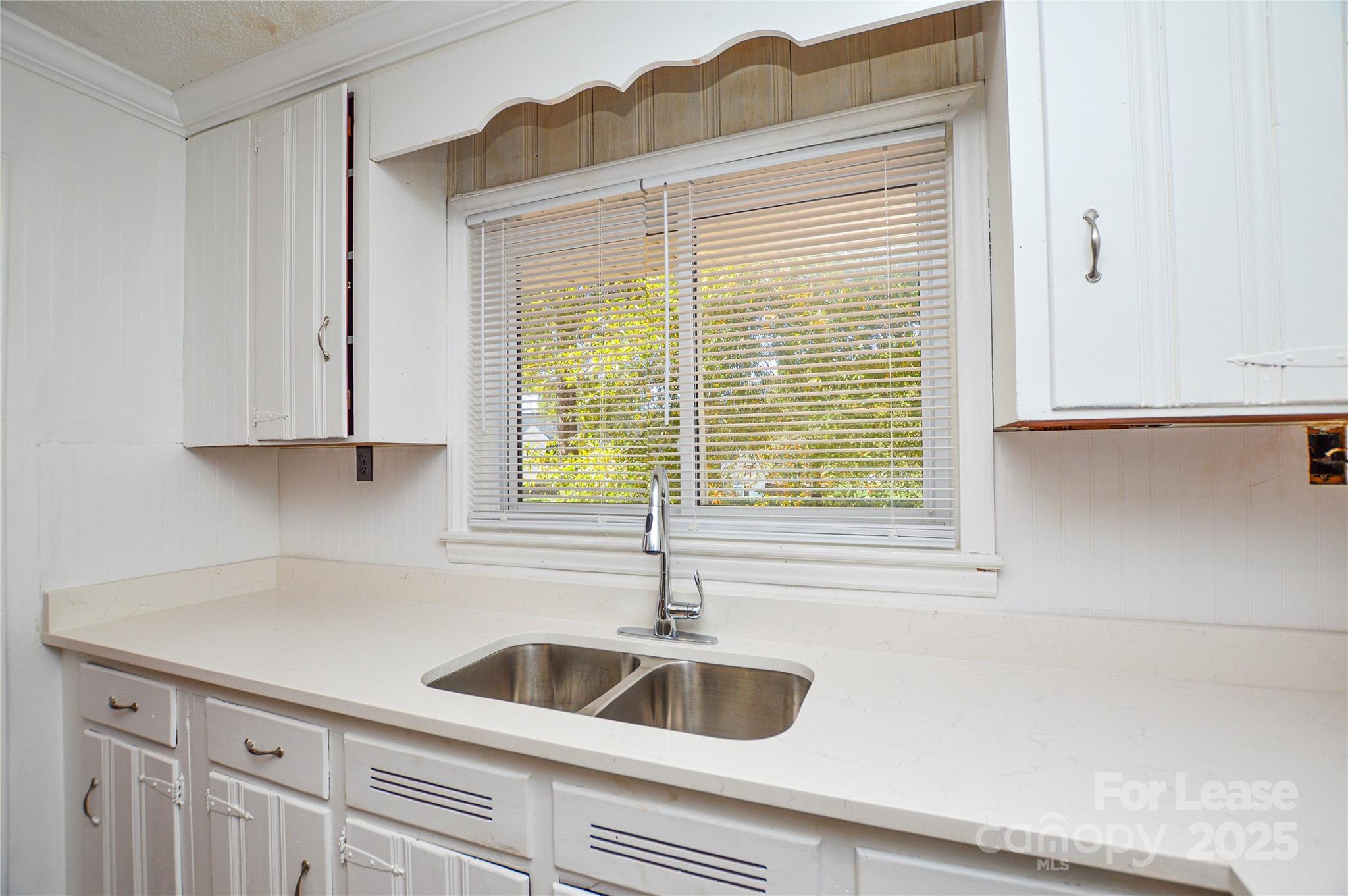 2511 Woodstar Road Matthews, NC 28105 - Photo 15 of 21 a kitchen with a sink and cabinets