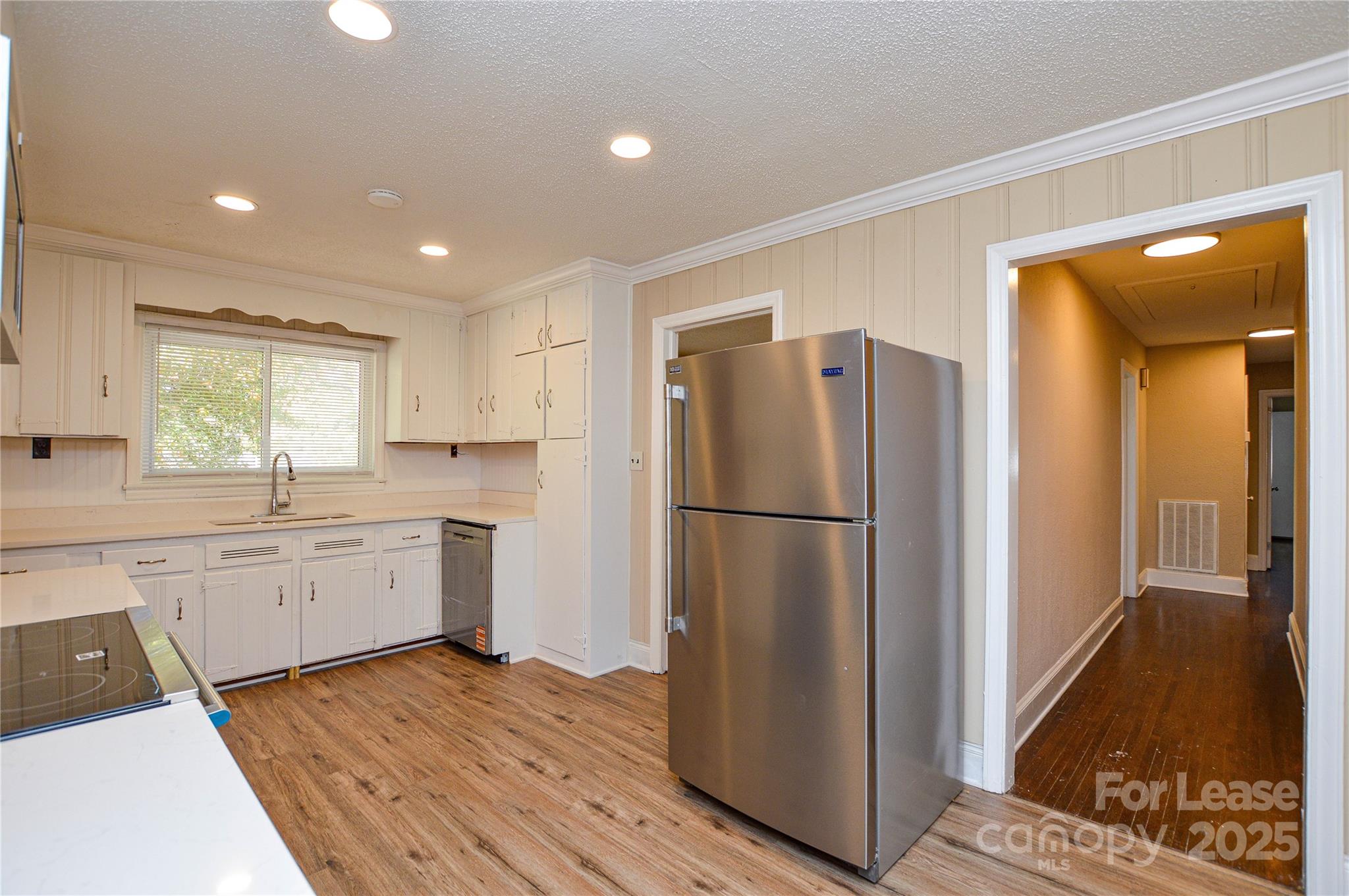 2511 Woodstar Road Matthews, NC 28105 - Photo 16 of 21 a kitchen with a refrigerator a sink and cabinets