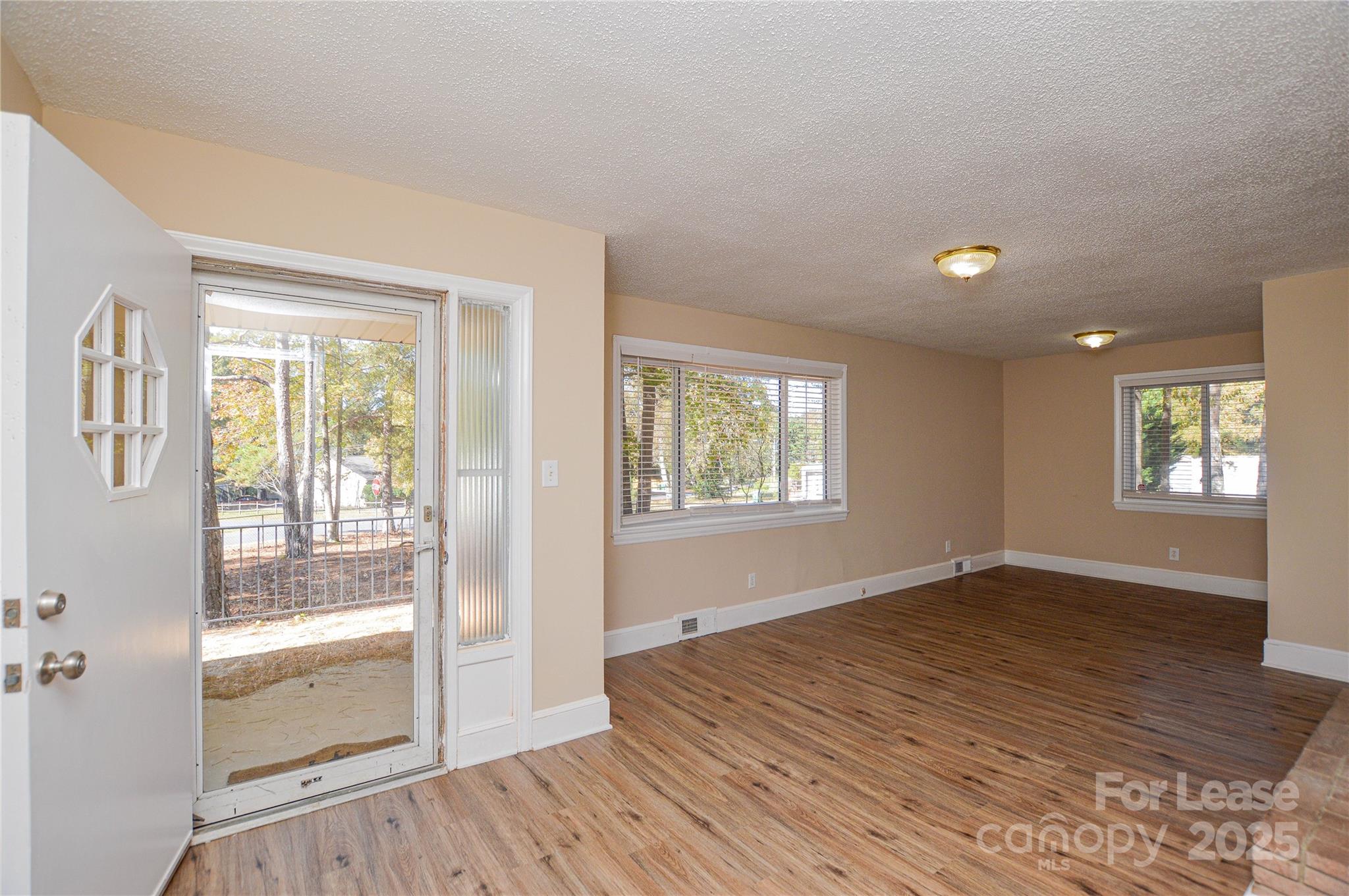 2511 Woodstar Road Matthews, NC 28105 - Photo 19 of 21 a view of an empty room with wooden floor and a window