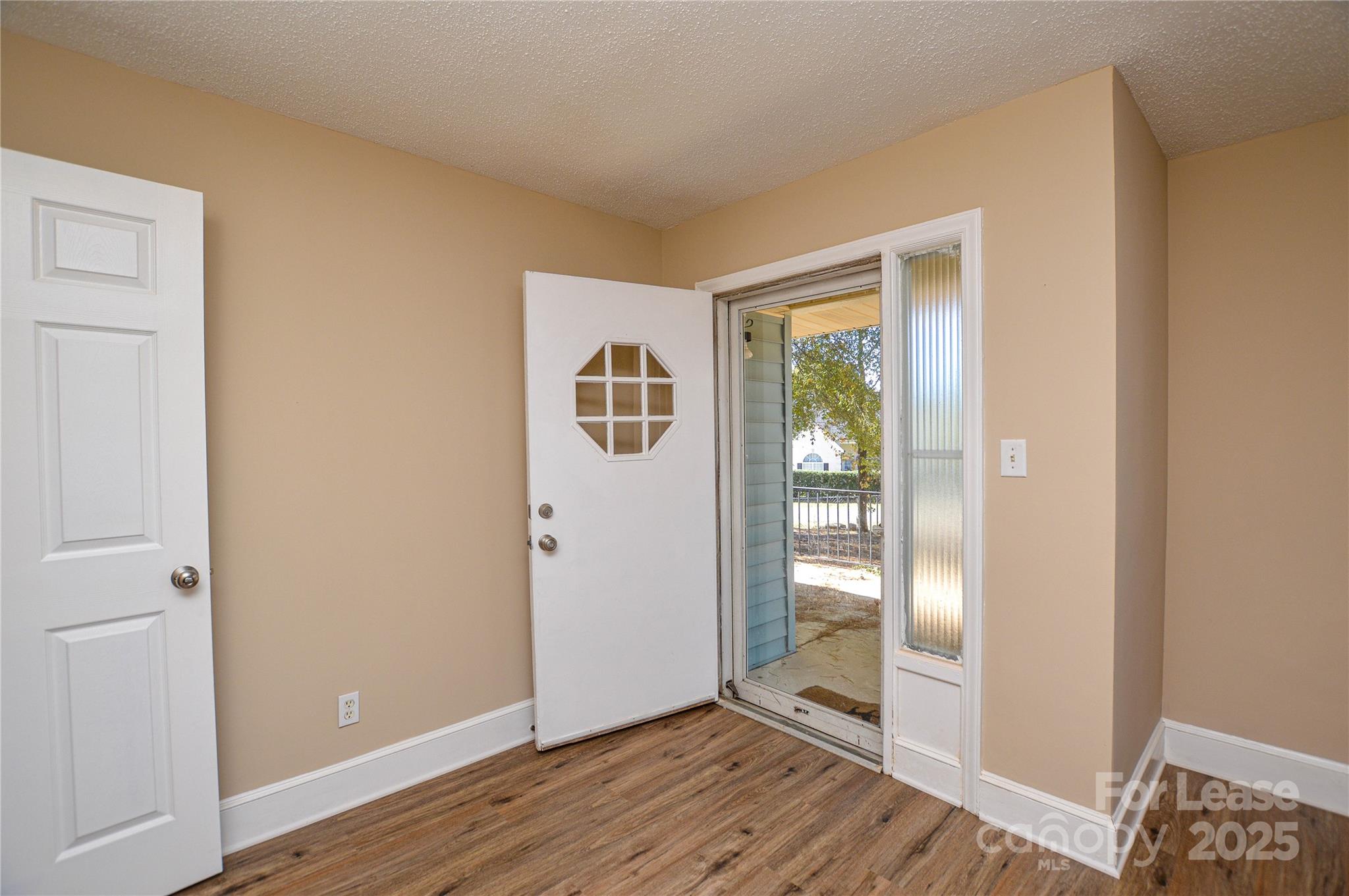 2511 Woodstar Road Matthews, NC 28105 - Photo 20 of 21 a view of an empty room with wooden floor and a window