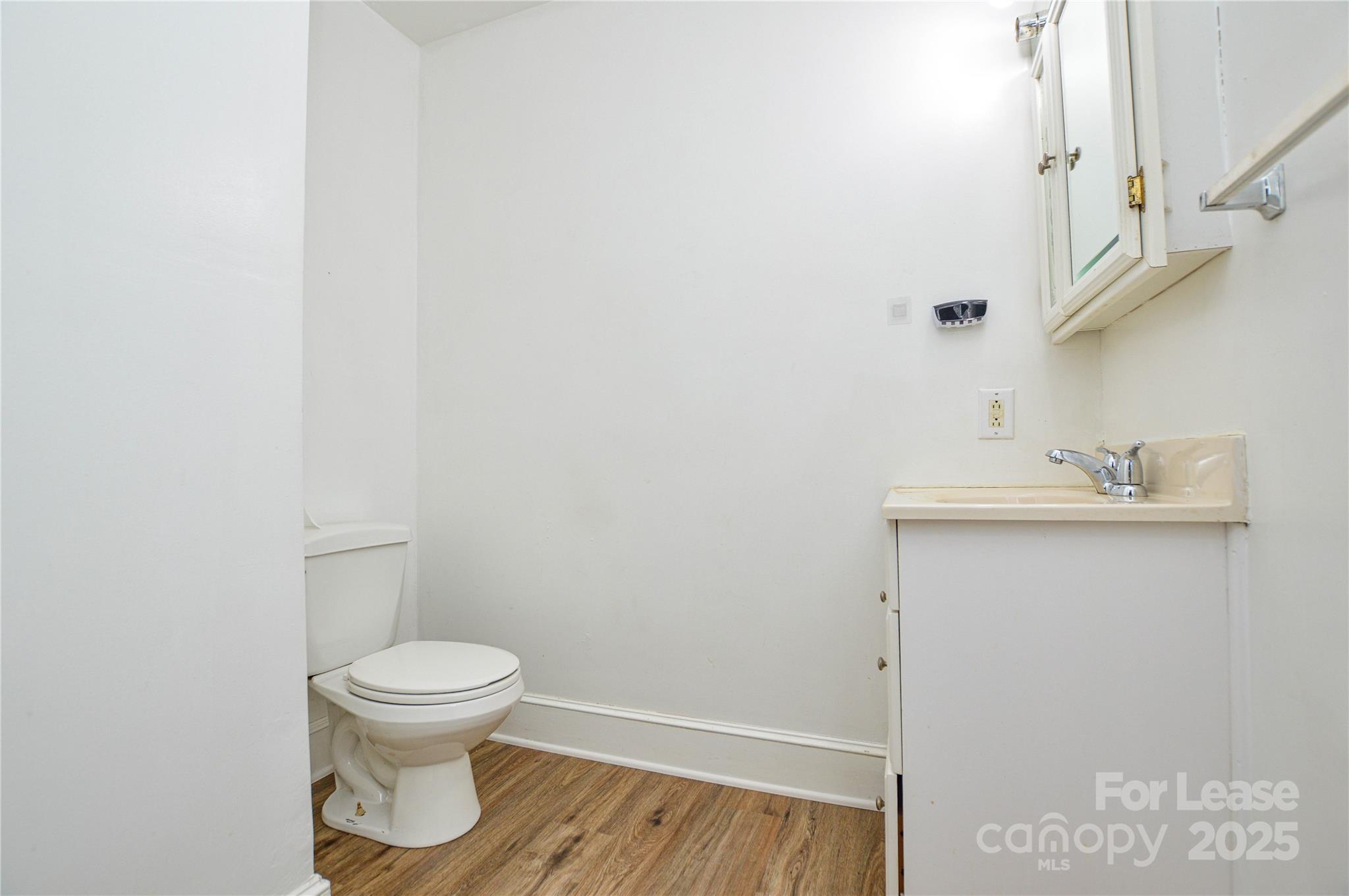2511 Woodstar Road Matthews, NC 28105 - Photo 3 of 21 a white toilet sitting next to a bathroom sink