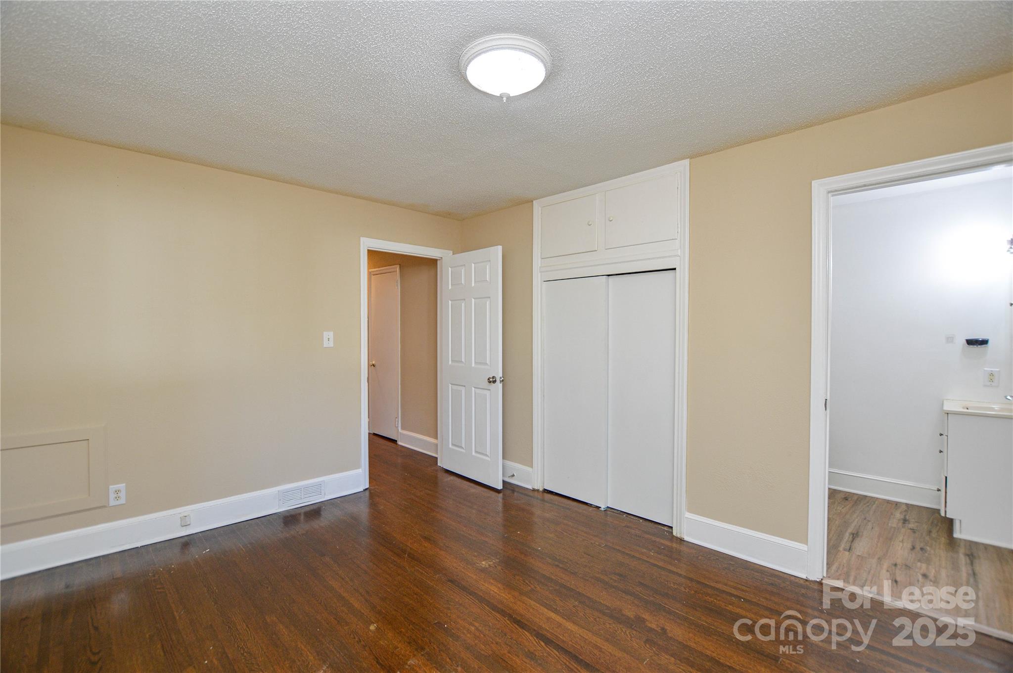 2511 Woodstar Road Matthews, NC 28105 - Photo 4 of 21 an empty room with wooden floor and windows