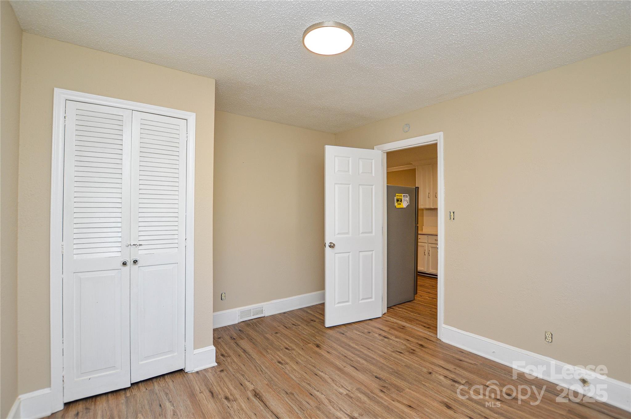 2511 Woodstar Road Matthews, NC 28105 - Photo 10 of 21 an empty room with wooden floor and closet