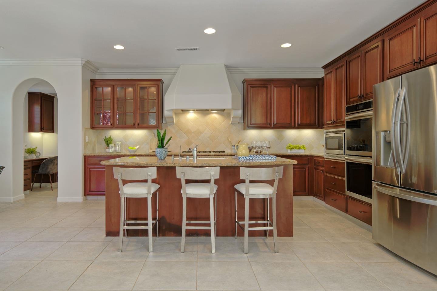7160 Eagle Ridge Drive Gilroy, CA 95020 - Photo 13 of 80 a kitchen with granite countertop stainless steel appliances a table and chairs