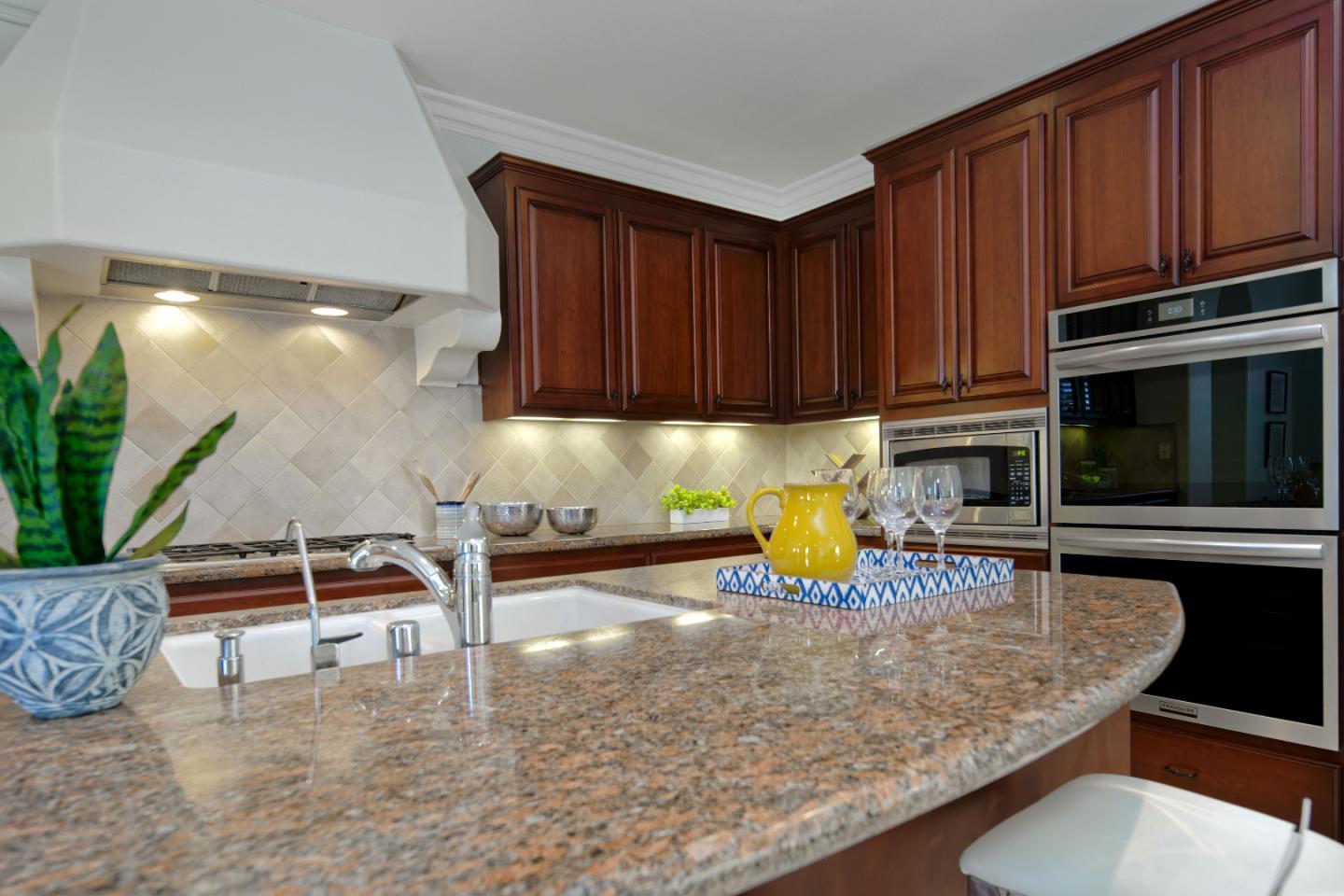 7160 Eagle Ridge Drive Gilroy, CA 95020 - Photo 15 of 80 a kitchen with wooden cabinets a oven and a sink