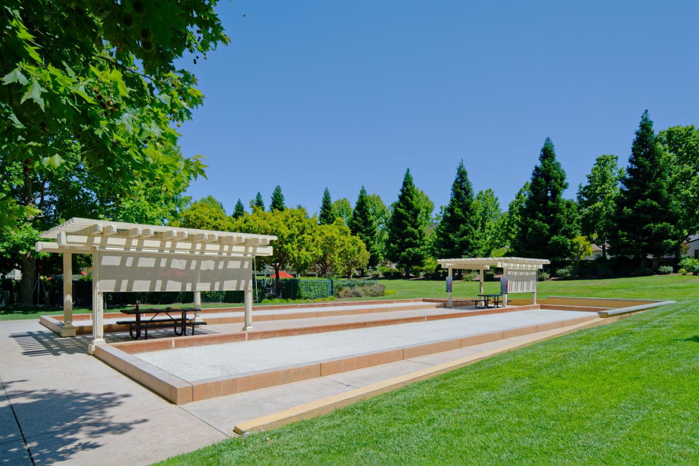 7160 Eagle Ridge Drive Gilroy, CA 95020 - Photo 77 of 80 a view of a patio with table and chairs potted plants and a palm tree