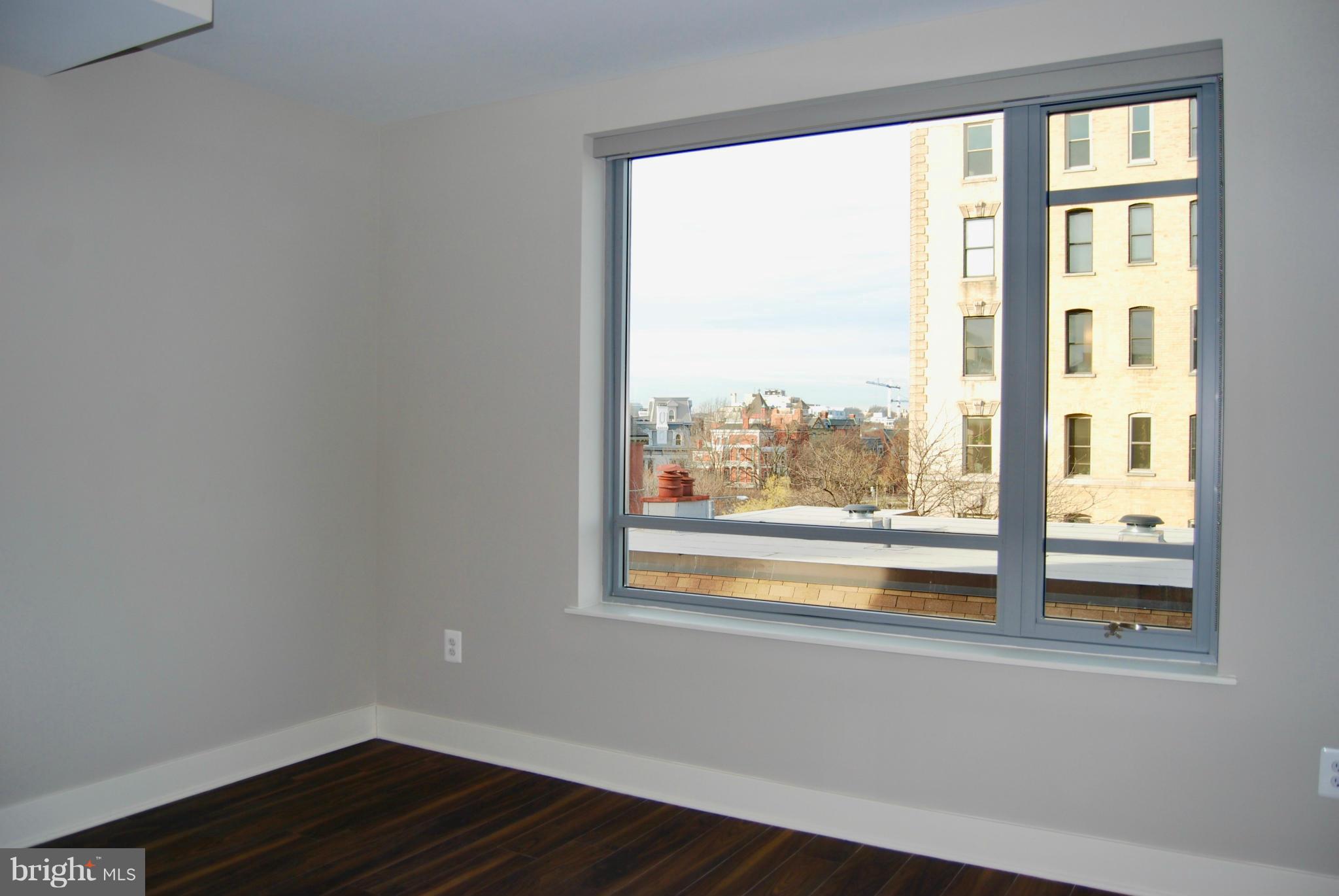 1311 13th Street Northwest, Unit 502 Washington, DC 20005 - Photo 12 of 21 a view of empty room with wooden floor and fan
