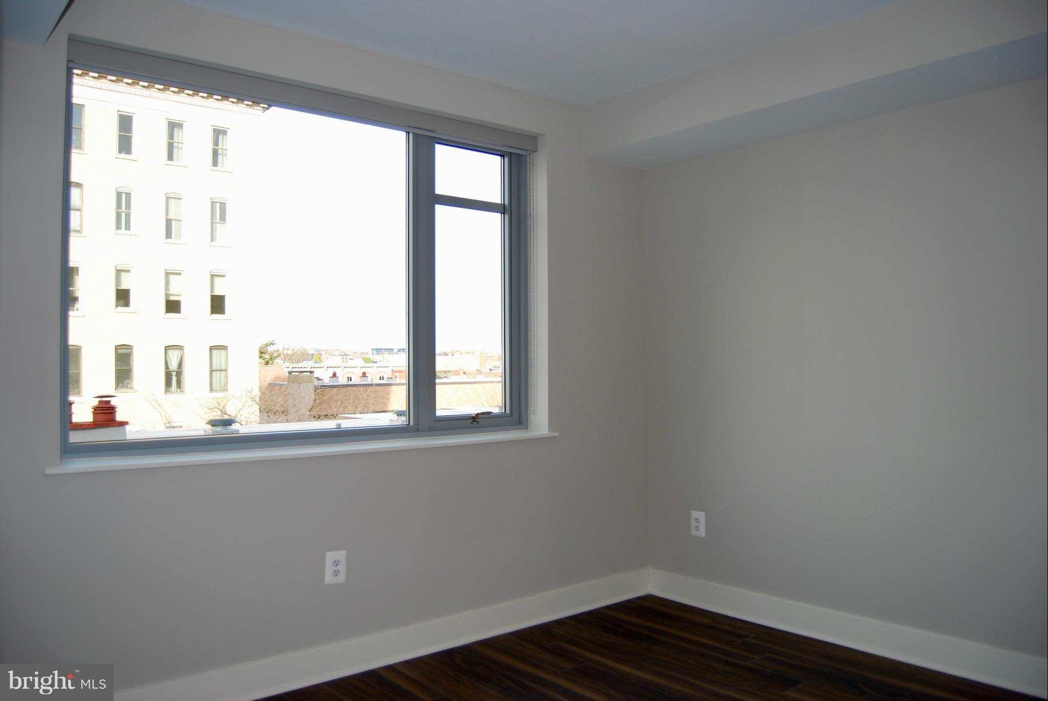 1311 13th Street Northwest, Unit 502 Washington, DC 20005 - Photo 16 of 21 a view of empty room with wooden floor and fan