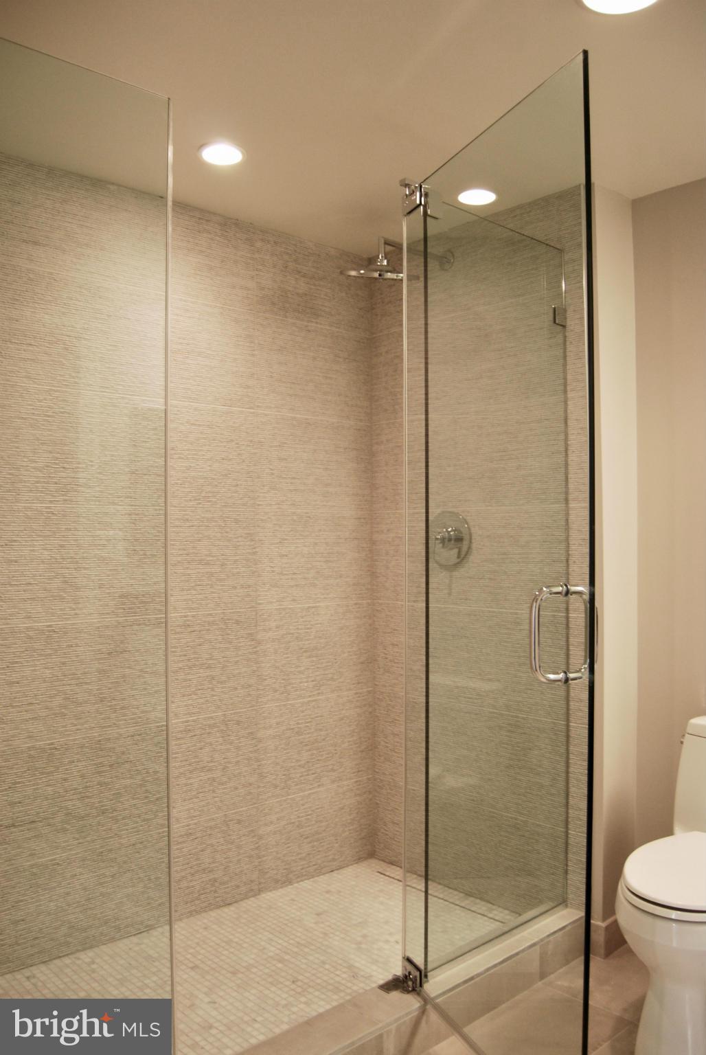 1311 13th Street Northwest, Unit 502 Washington, DC 20005 - Photo 17 of 21 a bathroom with a shower and a toilet