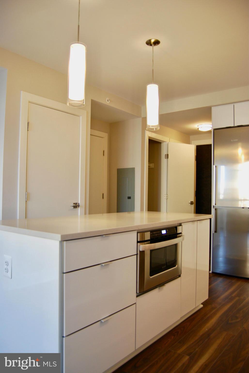 1311 13th Street Northwest, Unit 502 Washington, DC 20005 - Photo 10 of 21 a kitchen with a sink and a refrigerator
