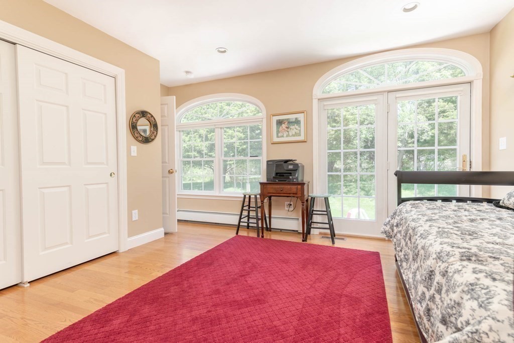 4 Elliston Road Weston, MA 02493 - Photo 15 of 36 a bedroom with a bed and a large window