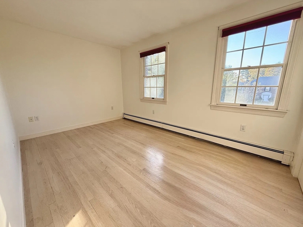 4 Elliston Road Weston, MA 02493 - Photo 20 of 36 an empty room with wooden floor and windows