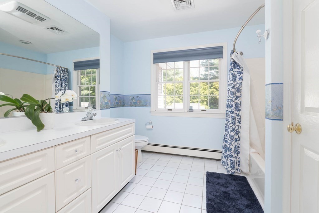 4 Elliston Road Weston, MA 02493 - Photo 21 of 36 a bathroom with a sink a mirror and a shower