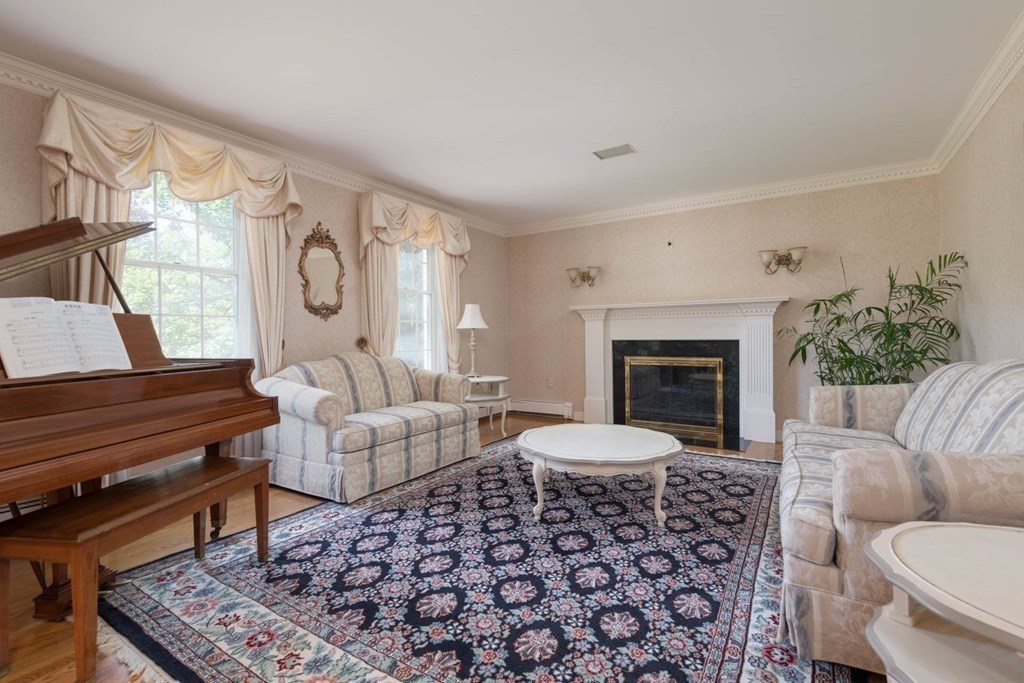 4 Elliston Road Weston, MA 02493 - Photo 4 of 36 a living room with furniture a fireplace and a large window